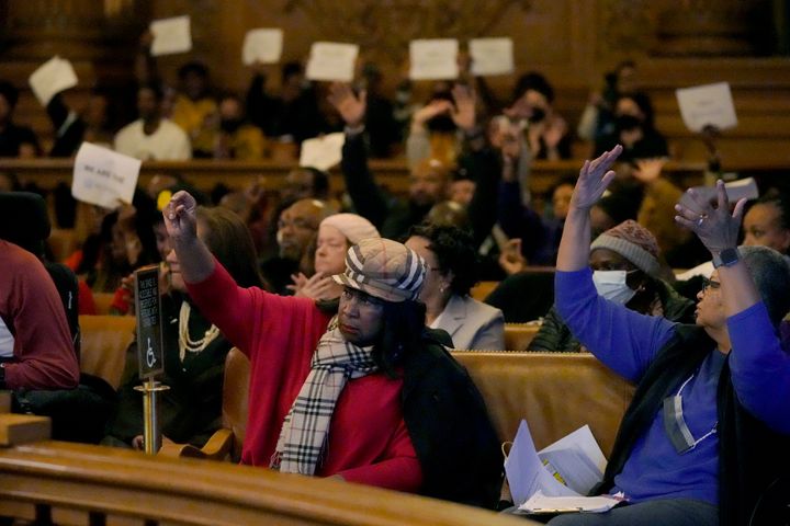 People react to speakers during a special Board of Supervisors hearing about reparations in San Francisco on Tuesday.