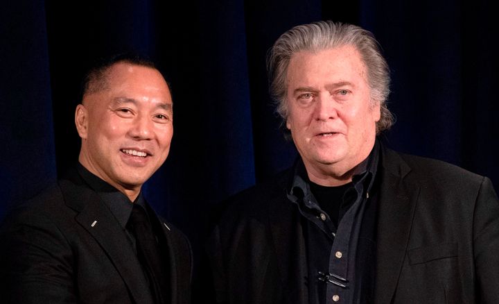 Former White House Chief Strategist Steve Bannon (R) greets fugitive Chinese billionaire Guo Wengui before introducing him at a news conference on November 20, 2018. (DON EMMERT/AFP via Getty Images)