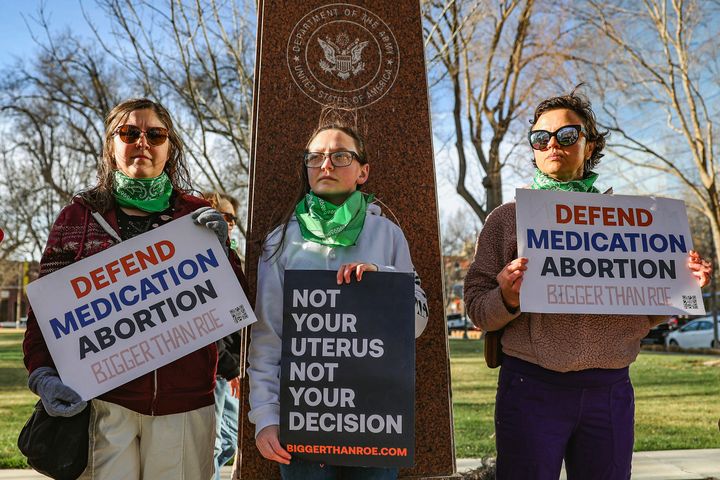Three members of the Women's March group protest in support of access to abortion medication outside the Federal Courthouse on Wednesday, March 15, 2023 in Amarillo, Texas. A conservative federal judge heard arguments Wednesday from a Christian group seeking to overturn the Food and Drug Administration’s more than 2-decade-old approval of an abortion medication, in a case that could threaten the most common form of abortion in the U.S. (AP Photo/David Erickson)