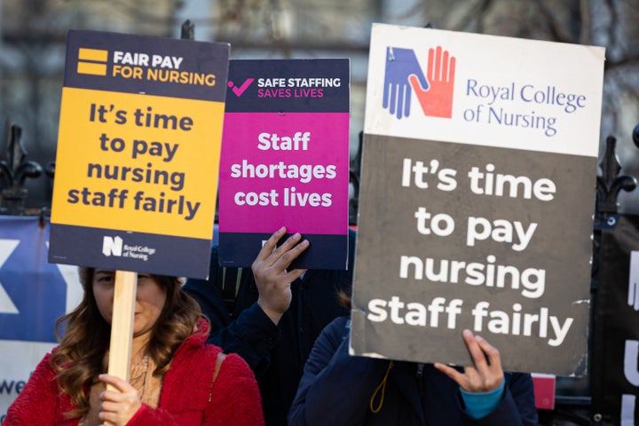 <strong>Nurses hold up placards expressing their opinion during the demonstration outside St Thomas' Hospital.</strong>