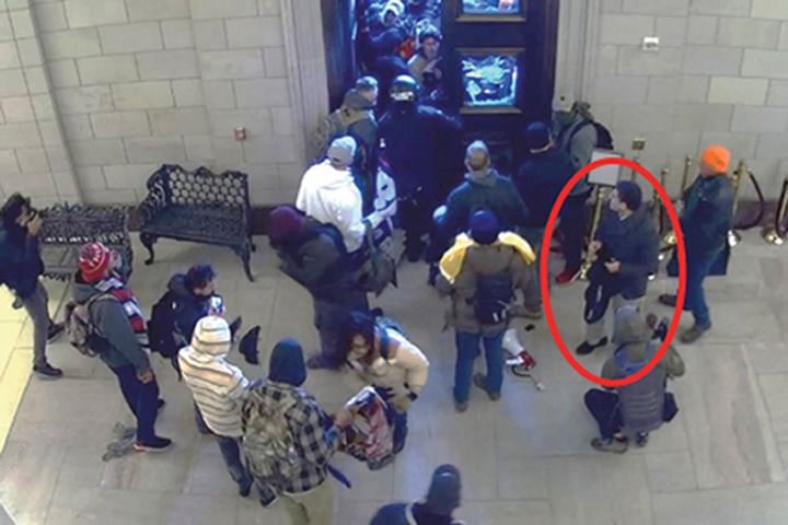 Elliot Resnick, circled, a former top editor of an Orthodox Jewish newspaper in New York City, was arrested Thursday on charges he interfered with police officers who were trying to protect the U.S. Capitol during the Jan. 6 riot.