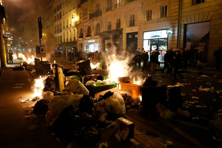 Garbage is set on fire by protesters after a demonstration near Concorde square, in Paris.