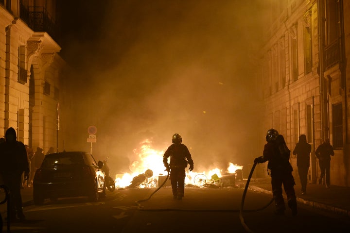 Firefighters put out a fire near Concorde square after a demonstration in Paris.