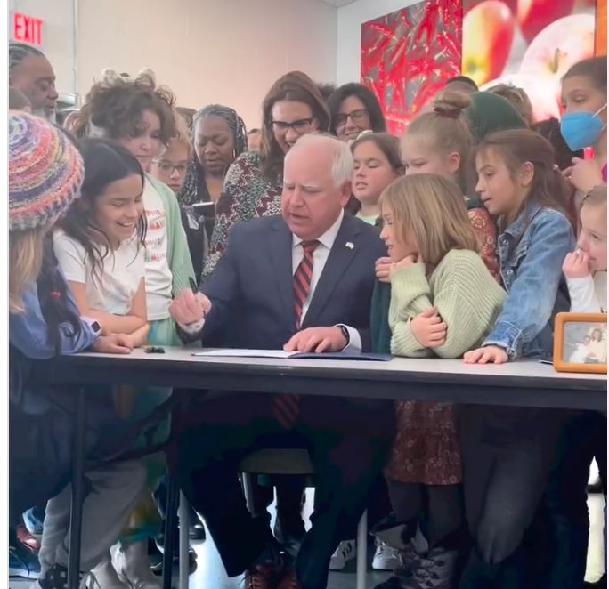 Minnesota Gov. Tim Walz (D) signs into law a free school lunch program for all students.