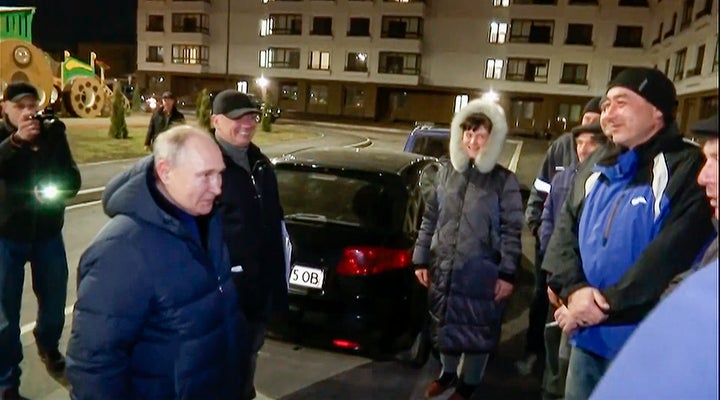 In this photo taken from video released by Russian TV Pool on Sunday, March 19, 2023, Russian President Vladimir Putin talks with local residents during his visit to Mariupol in Russian-controlled Donetsk region, Ukraine. Putin has traveled to Crimea to mark the ninth anniversary of the Black Sea peninsula's annexation from Ukraine. (Pool Photo via AP)