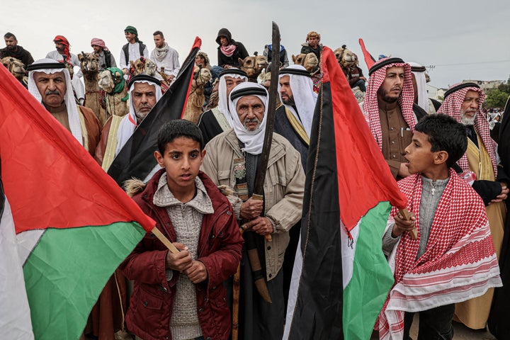 Palestinians ride camels during an event marking the 47th anniversary of Land Day in Deir al-Balah in the central Gaza Strip on March 18, 2023. Land Day commemorates the events of March 30, 1976, when Israeli troops shot and killed six people among Arab Israelis and Palestinians protesting land confiscations.