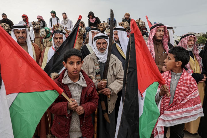 Palestinians ride camels during an event marking the 47th anniversary of Land Day in Deir al-Balah in the central Gaza Strip on March 18, 2023. Land Day commemorates the events of March 30, 1976, when Israeli troops shot and killed six people among Arab Israelis and Palestinians protesting land confiscations. 