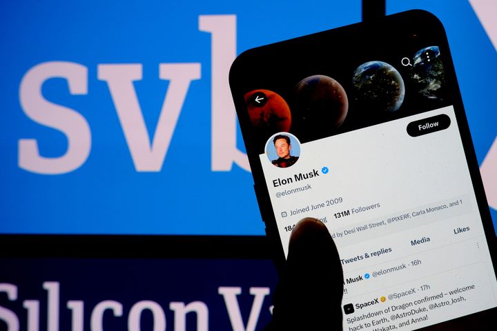 In this photo illustration, a Twitter account of Elon Musk is displayed on a smartphone with a Silicon Valley Bank logo in the background.