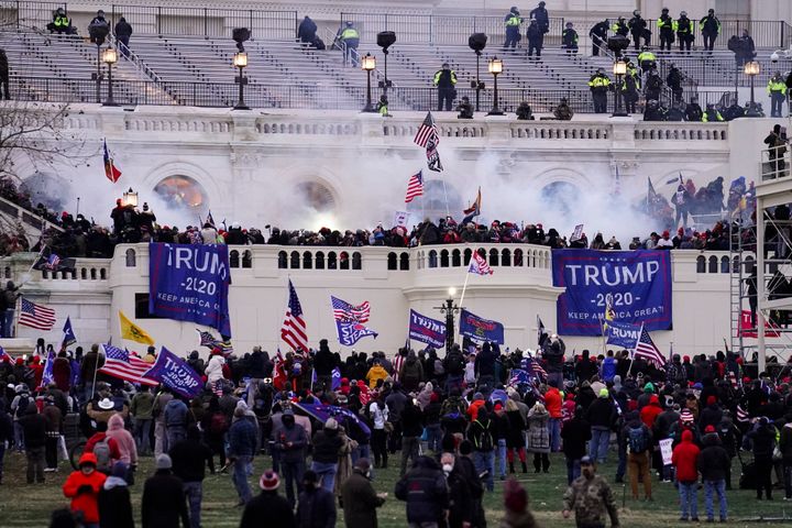 Violent insurrectionists loyal to then-President Donald Trump are seen storming the U.S. Capitol on Jan. 6, 2021. On Tuesday a 31-year-old Virginia man was sentenced to more than four years in prison for his participation in the riot. 
