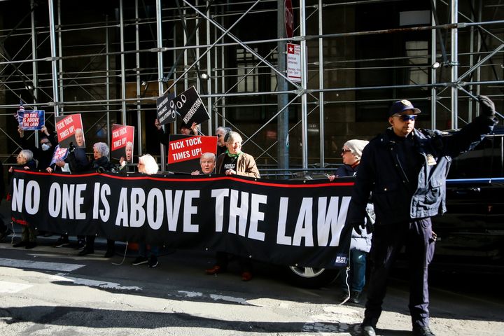 Demonstrators gather Tuesday outside Manhattan Criminal Court in anticipation of a grand jury voting this week on whether to indict former President Donald Trump in connection with an investigation into a secret money scheme involving adult film star Stormy Daniels.