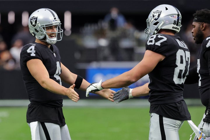 Quarterback Derek Carr, left, and tight end Foster Moreau celebrate during a 2022 game against the Houston Texans in Las Vegas.