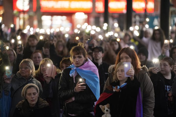 Members of the public hold their phones with the torch function set during a moment of silence as they attend a candle-lit vigil at Old Market Place in Warrington, in memory of transgender teenager Brianna Ghey, who was fatally stabbed in a park.