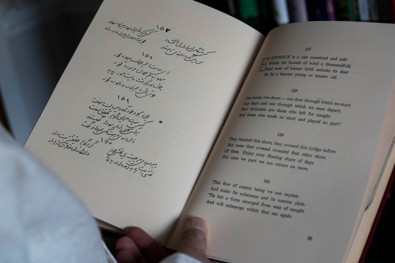 Muhammad Ali Mojaradi with a book of Persian poetry translated into English on the right side at his home in Troy, Michigan, on Sunday, March 19, 2023. Mojaradi said his PayPal account was frozen three times and that more than two dozen payments made to him were flagged over three years.