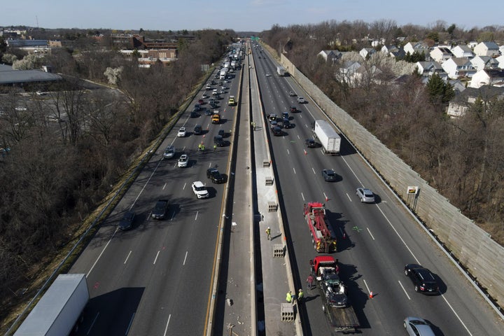 Emergency personnel work at the scene of a fatal crash along Interstate 695 on Wednesday, March 22, 2023, near Woodlawn, Md. Multiple people were killed when a passenger vehicle pulled into a work zone along the Baltimore beltway and struck construction workers there, Maryland State Police said Wednesday. (AP Photo/Julio Cortez)