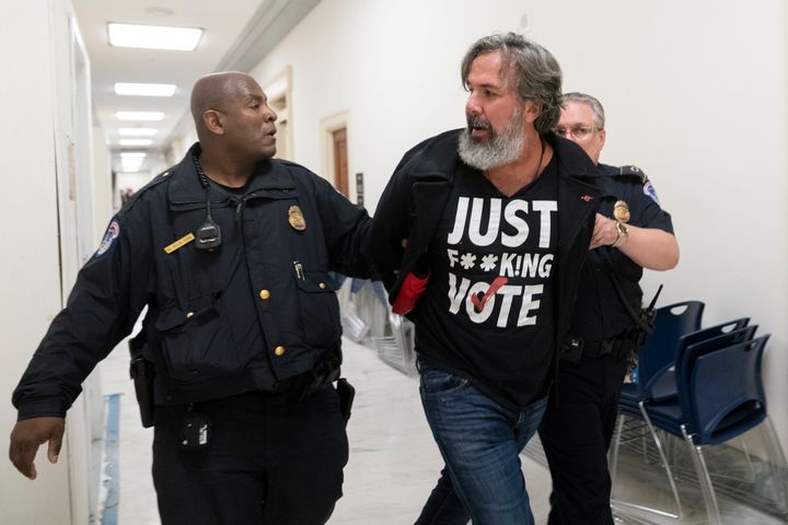 Manuel Oliver, the father of Joaquin Oliver, one of the victims of the 2018 mass shooting at Marjory Stoneman Douglas High School in Parkland, Florida, is removed from the hearing room for disturbing a hearing on Capitol Hill.