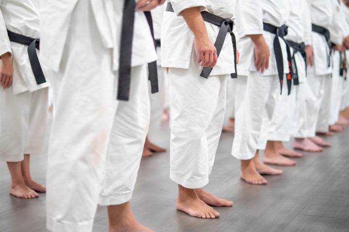 They lie on the tatami in karate attire