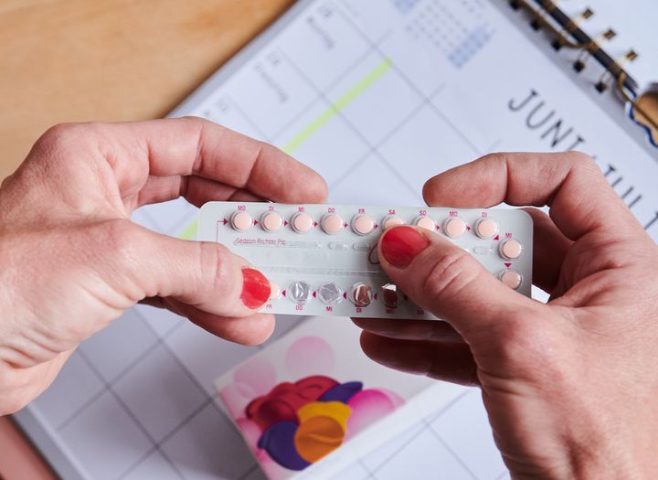 A woman takes the next pill from the monthly pack of the contraceptive pill. Photo: Annette Riedl/dpa (Photo by Annette Riedl/picture alliance via Getty Images)