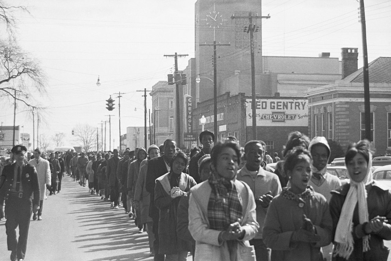 Alabama state troopers are seen with Black youths who were arrested during civil rights demonstrations.