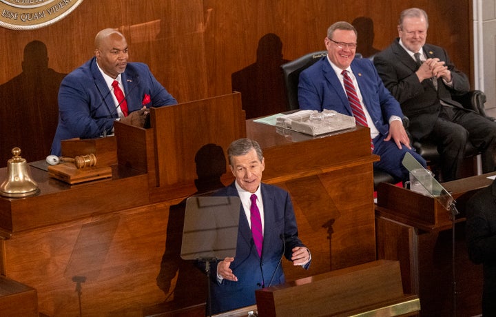Gov. Roy Cooper (D) delivers his State of the State address to a joint session of the N.C. General Assembly on March 6 as, from left, Lt. Gov. Mark Robinson (R), House Speaker Tim Moore (R) and Senate Leader Phil Berger (R) look on.