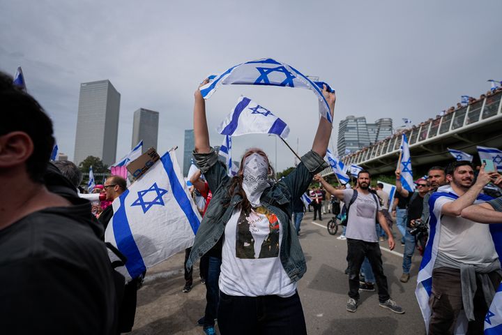 Demonstrators block a highway during protest against plans by Prime Minister Benjamin Netanyahu's government to overhaul the judicial system in Tel Aviv, Israel, Thursday, March 23, 2023.