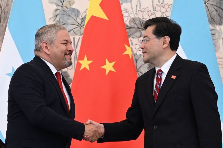 Honduras Foreign Minister Eduardo Enrique Reina and Chinese Foreign Minister Qin Gang shake hands following the establishment of diplomatic relations between the two countries, during a joint statement after a ceremony in the Diaoyutai State Guesthouse in Beijing on March 26, 2023.
