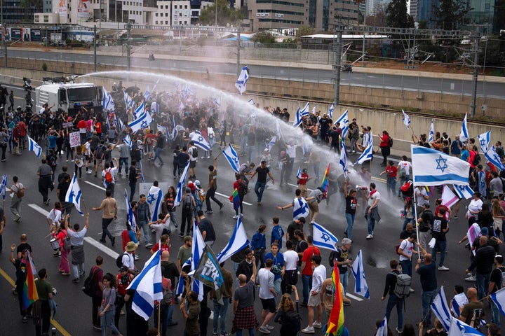 Israeli police use a water cannon to disperse Israelis blocking the freeway during a protest against plans by Netanyahu's government to overhaul the judicial system in Tel Aviv, Israel, on March 23.