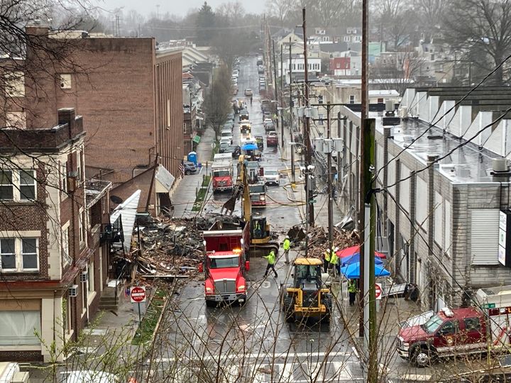 Emergency responders and heavy equipment are seen Saturday at the site of a deadly explosion at a chocolate factory in West Reading, Pennsylvania.