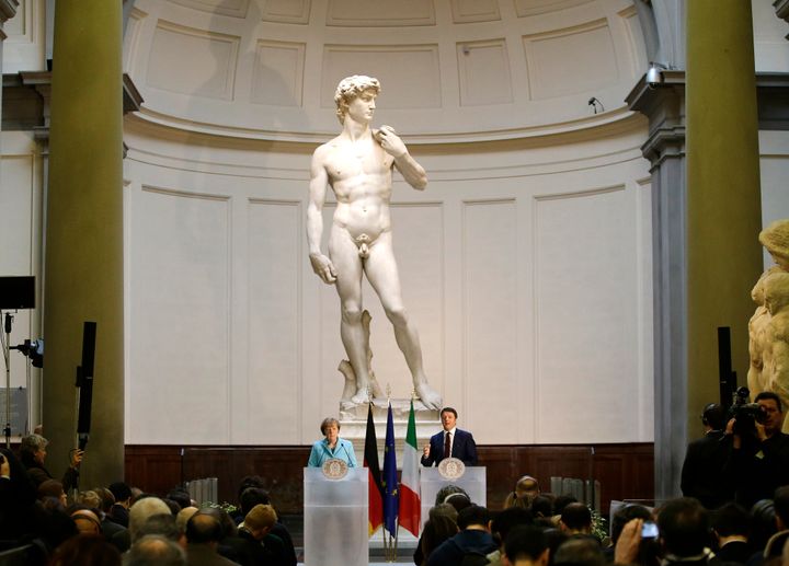 Then-German Chancellor Angela Merkel, left, and Italian Prime Minister Matteo Renzi speak during a press conference in front of Michelangelo's "David statue" in Florence, Italy, in 2015.