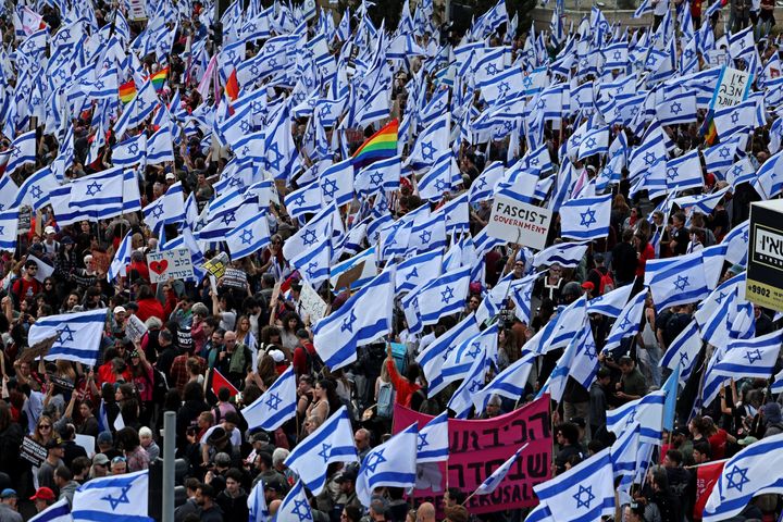 Protesters gather with national flags outside Israel's parliament in Jerusalem on Monday amid ongoing demonstrations and calls for a general strike against the hard-right government's push to overhaul the justice system.