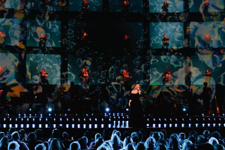 During “Skyfall,” a screen at the rear of the behemoth stage is illuminated to reveal a 24-piece string section perched atop rows of scaffolding.