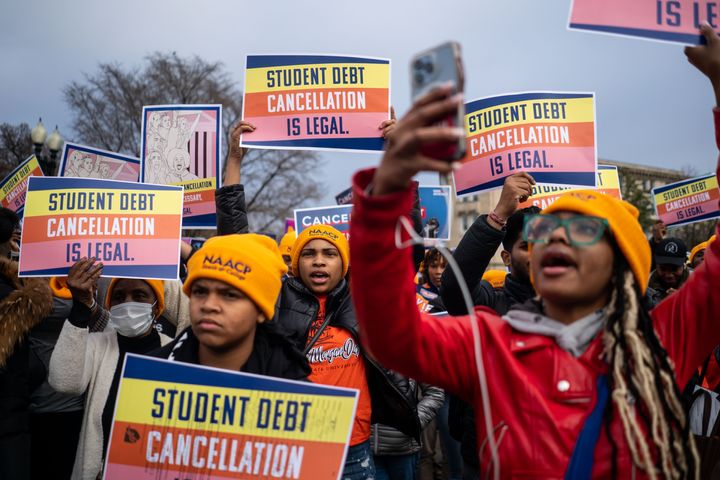 People rally to show support for the Biden administration's student debt relief plan in front of the the Supreme Court of the United States on Feb. 28 as the court heard arguments in a case that could decide the fate of the program.