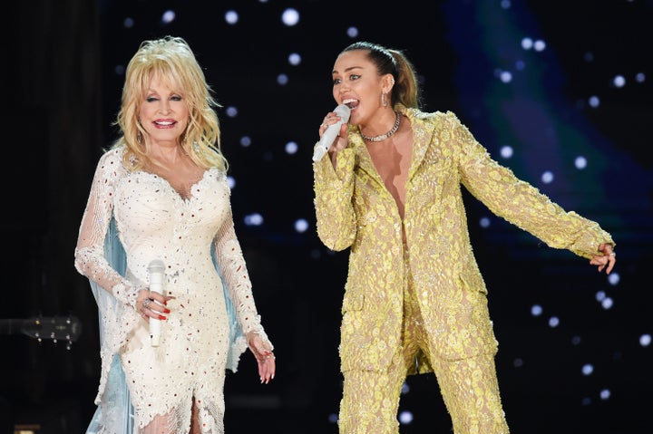 Dolly Parton (left) and Miley Cyrus performing at the 2019 Grammy Awards. 