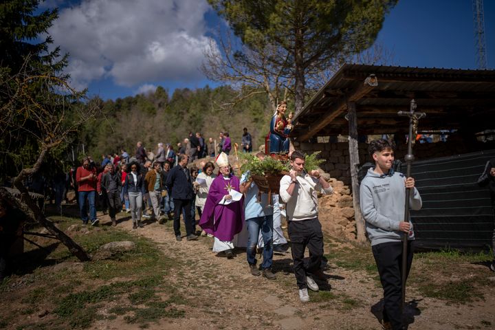 Local residents take part in a procession carrying a replica of the Our Lady of the Torrents, a virgin historically associated with drought, in l'Espunyola, north of Barcelona, Spain.