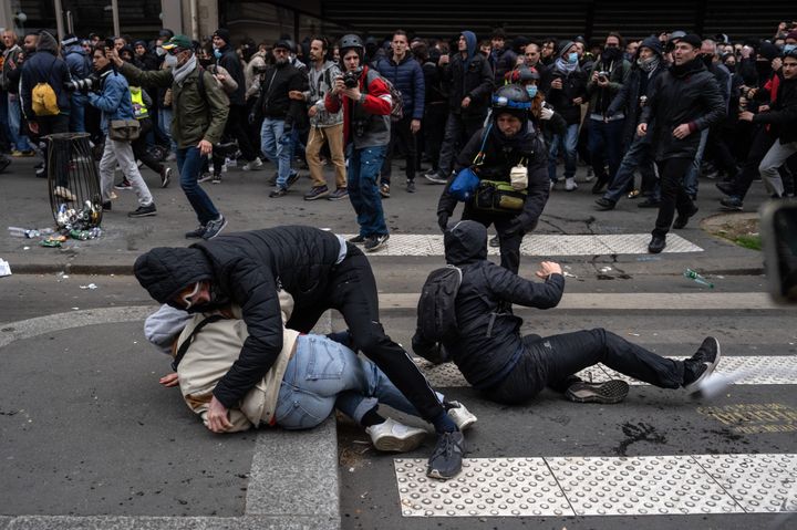 PARIS, FRANCE - MARCH 28: People fall over as police charge during a rally against pension reforms on March 28, 2023 in Paris, France. The country has experienced weeks of protests and strike actions related to a rise in the pension age, which was passed last week. The 10th day of nationwide protests in France against the pension reforms are also calling out the police brutality from pervious strikes. (Photo by Carl Court/Getty Images)