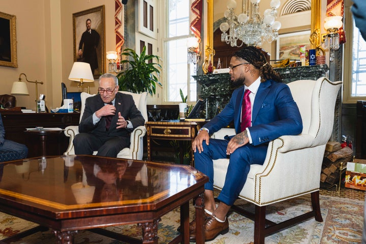 Buffalo Bills safety Damar Hamlin sits with Senate Majority Leader Chuck Schumer.