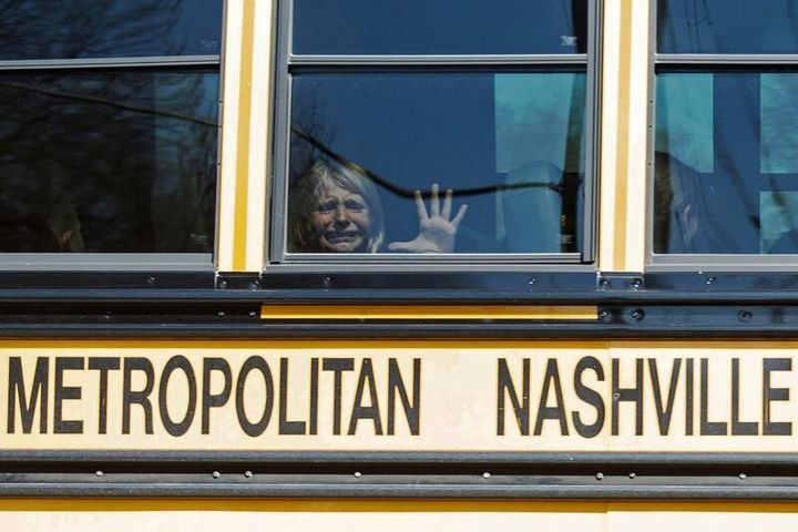 A child weeps while on the bus leaving The Covenant School, following a mass shooting at the school in Nashville, Tennessee, on March 27, 2023. 