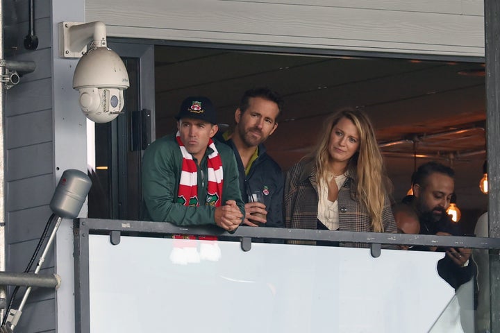 Wrexham AFC owners Rob McElhenney and Ryan Reynolds watch with Reynolds' wife, Blake Lively, during a match between Wrexham and York City at the Racecourse Ground on March 25.