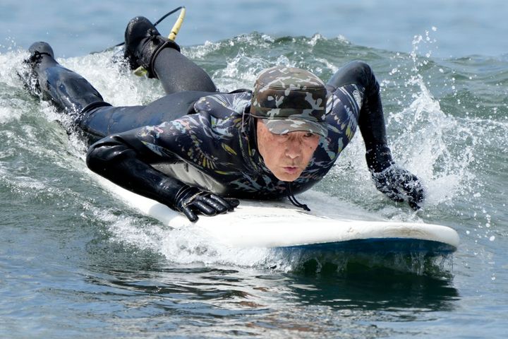 Seiichi Sano, an 89-year-old Japanese man, has been recognized by the Guinness World Records as the oldest male to surf. (AP Photo/Eugene Hoshiko)
