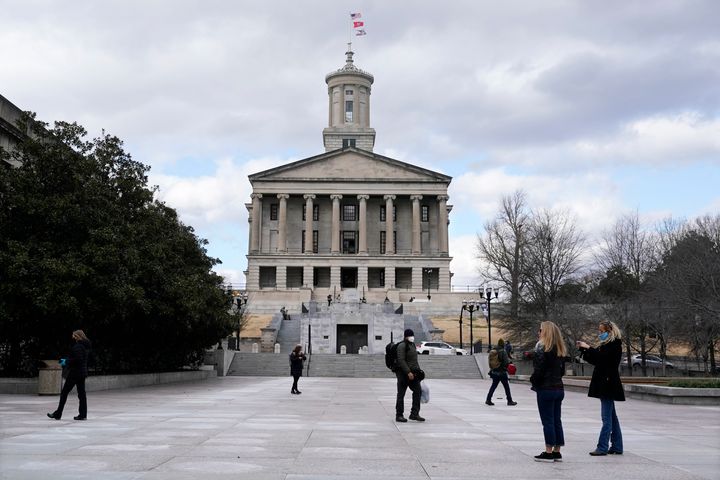 People walk across the Legislative Plaza in front of the state Capitol on Sunday, Jan. 17, 2021, in Nashville, Tennessee.