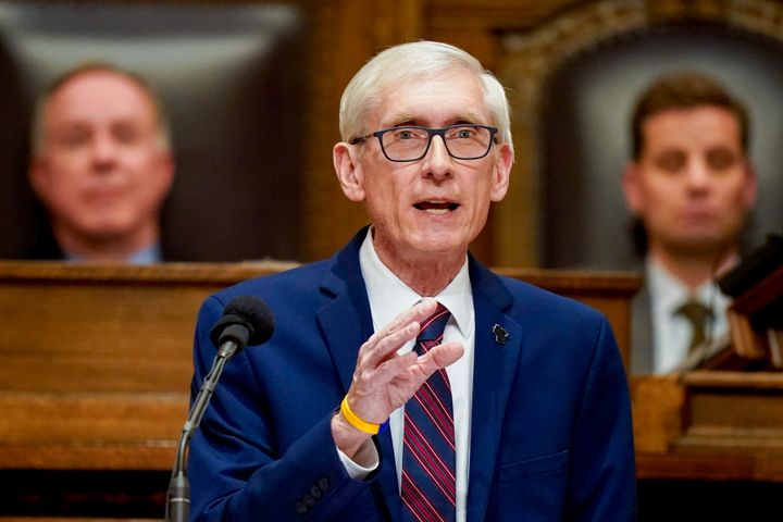 Wisconsin Gov. Tony Evers addresses a joint session of the legislature in Feb. 2022. Behind Evers is Republican Assembly Speaker Robin Vos (left) and Republican Senate President Chris Kapenga.