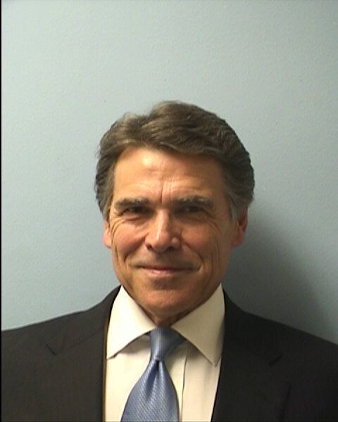 Texas Gov. Rick Perry posed for a mug shot photo in August, 2014 after he was indicted on felony charges of abuse of power and coercion of a public servant. (Photo by Travis County Sheriffs Office via Getty Images)