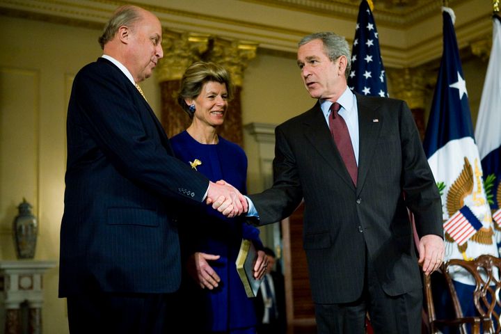 WASHINGTON - FEBRUARY 27: U.S. President George W. Bush (R) shakes hands with John Negroponte (R) before he takes his oath as Deputy Secretary of State as Negroponte's wife Diana looks on, during his oath of office ceremony at the State Department February 27, 2007 in Washington, DC. Negroponte, the former director of national intelligence, will work under Secretary of State Condoleeza Rice. (Photo by Jay Clendenin-Pool/Getty Images)