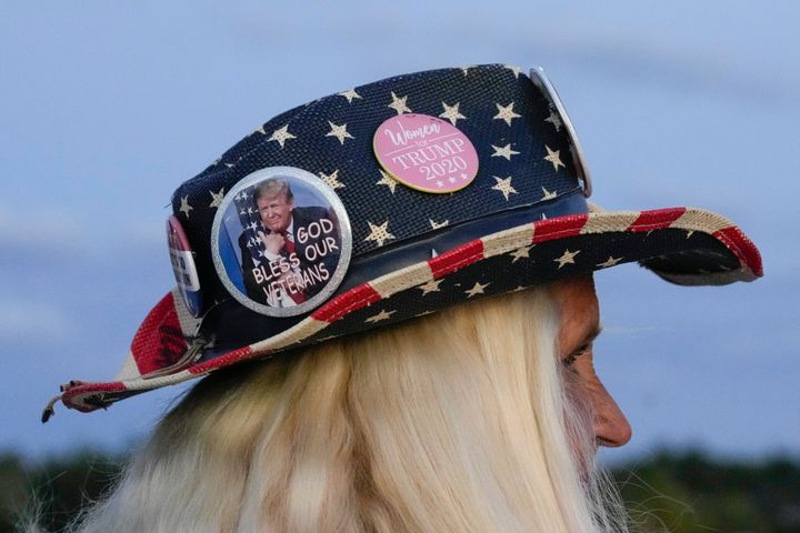 Kathy Clark of Lantana, Fla., wears an American flag hat with Trump pins as she shows her support for former President Donald Trump following the news that he had been indicted by a Manhattan grand jury on Thursday.