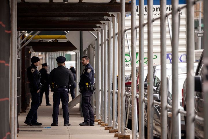 Law enforcement personnel stand outside Manhattan Criminal Court in New York on Friday.