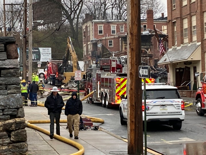 Emergency personnel and heavy equipment work at the site of the explosion last weekend.