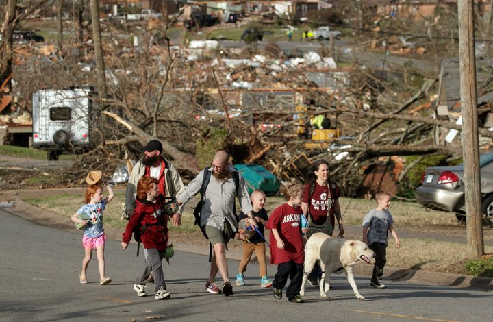 A family evacuates their Walnut Ridge neighborhood near Little Rock on Friday.