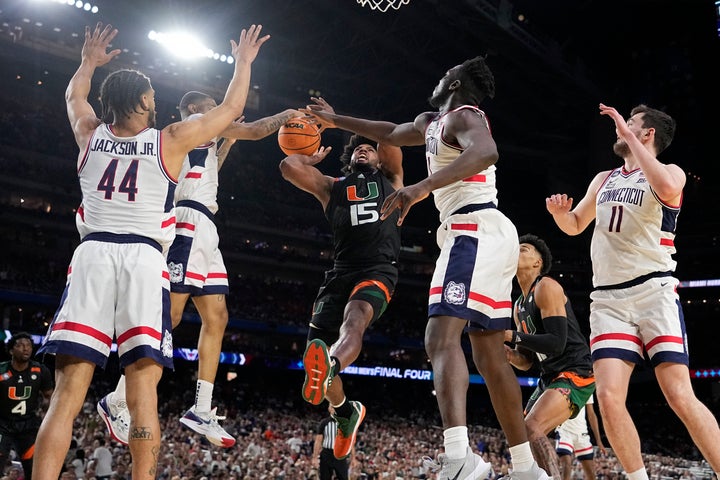 Miami forward Norchad Omier is blocked by Connecticut during the second half of a Final Four game in the NCAA Tournament on Saturday.