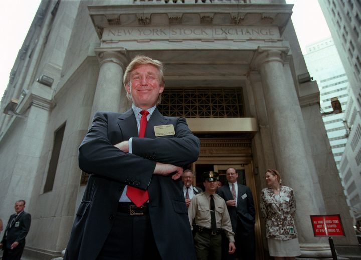 Donald Trump poses for photos outside the New York Stock Exchange after the listing of his stock on Wednesday, June 7, 1995, in New York. (AP Photo/Kathy Willens, File)