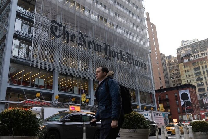 A pedestrian walks by the New York Times building in Manhattan, New York.