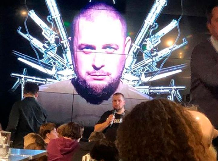 Russian blogger Vladlen Tatarsky speaks during a party in front of projection of an image of him, before an explosion at a cafe in St. Petersburg, Russia, Sunday, April 2, 2023. (AP Photo)